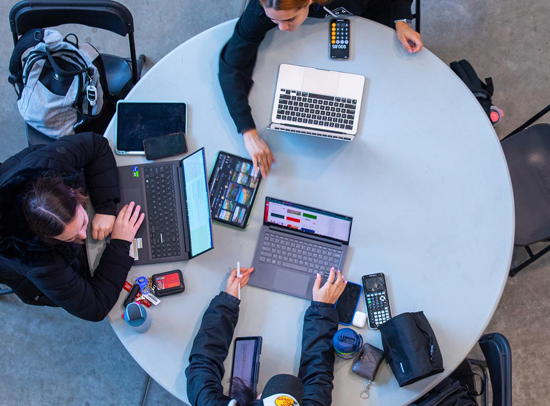 A trio of students work together inside Howe Hall