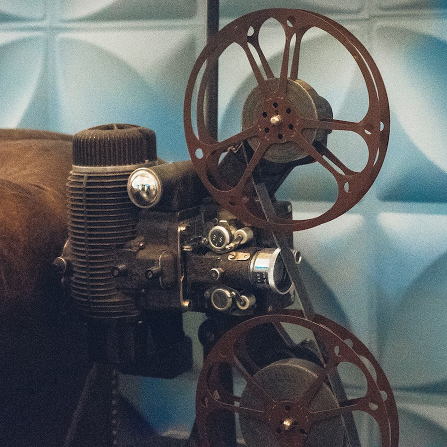 Vintage film projector with two reels and filmstrip loaded