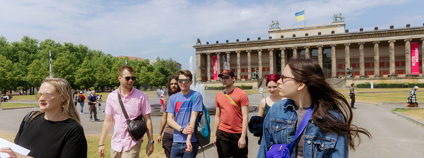 Several Study Abroad students in sunglasses walking near a landmark in Berlin