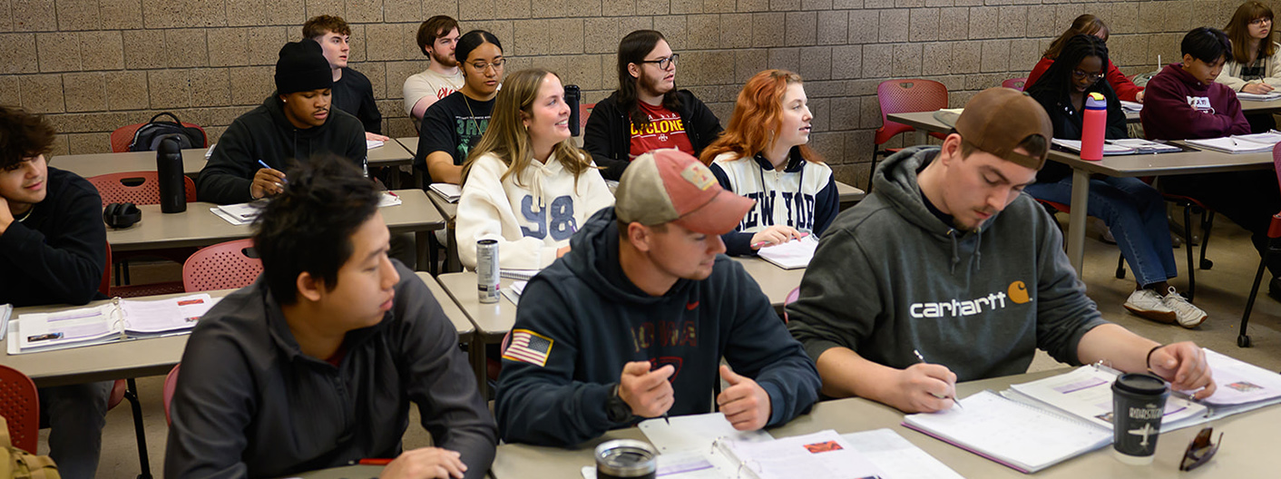 A group of students listening intently at a lecture in WLC